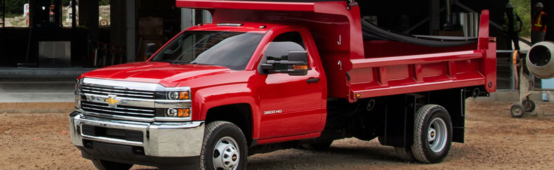 Red 2017 Norstar Dump Trailer DT14 truck parked in front of a worksite